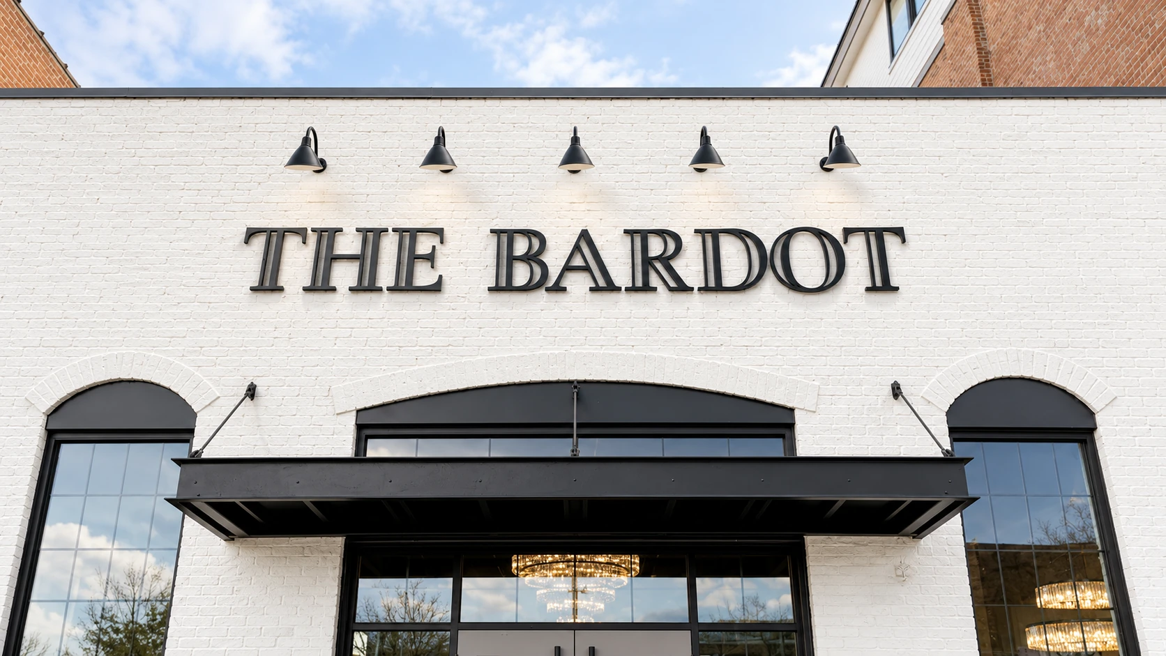 Black cast-metal lettering above The Bardot entrance
